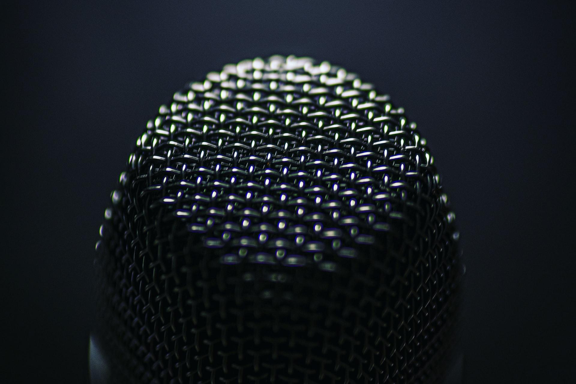 silver microphone on black background